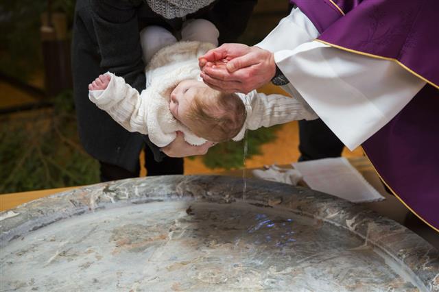 Priest Is Baptizing Little Baby Girl