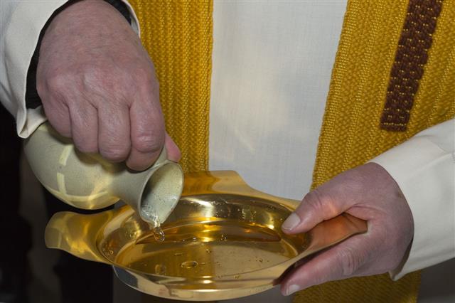 Pouring Holy Water For A Baptism