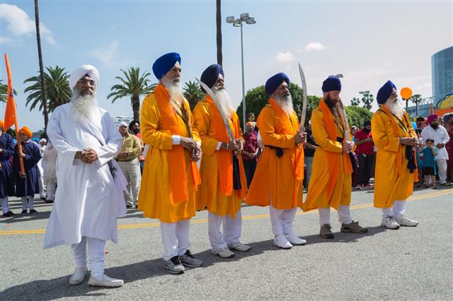 Sikhs With Blue Turbans Holding Swords