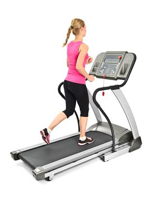 Young Woman Doing Exercises On Treadmill