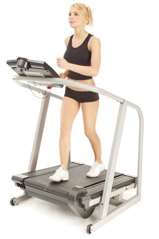Attractive Young Woman On Treadmill