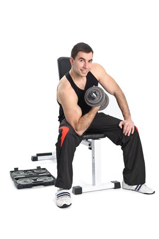 Young Man Posing With Dumbbell