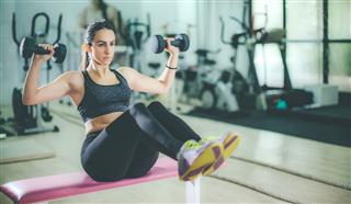 Woman Exercising At The Gym
