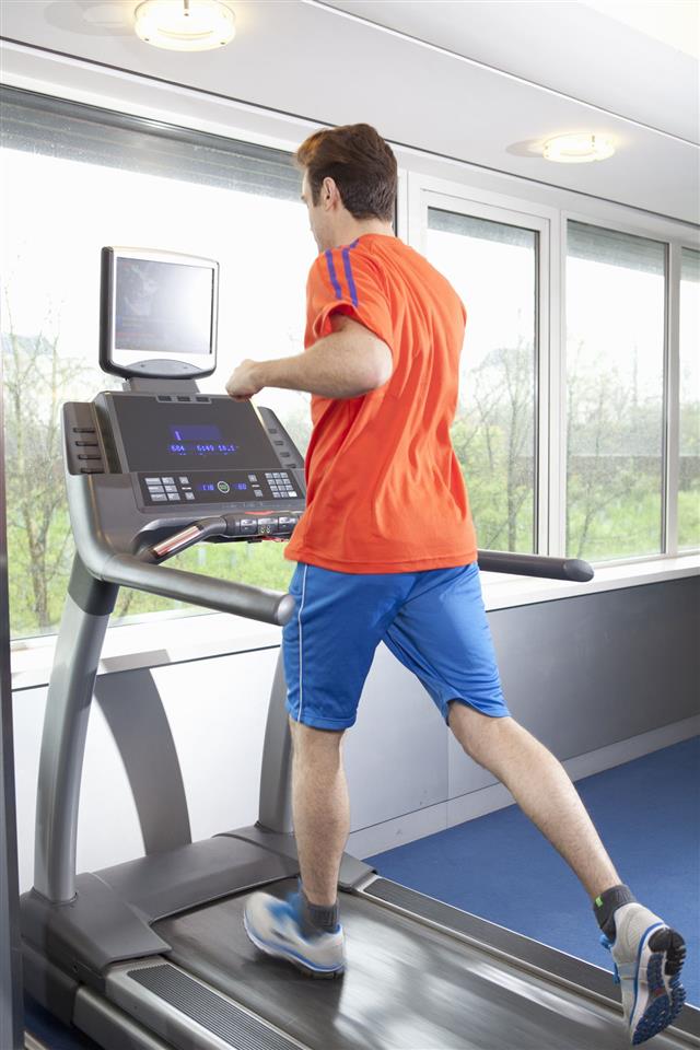 Man Running On Treadmill In Gym