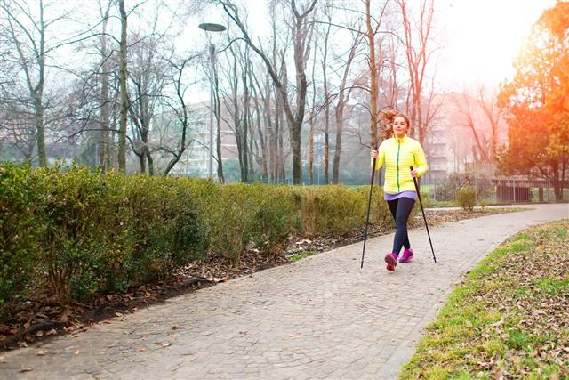 Girl Make Nordic Walking In Park