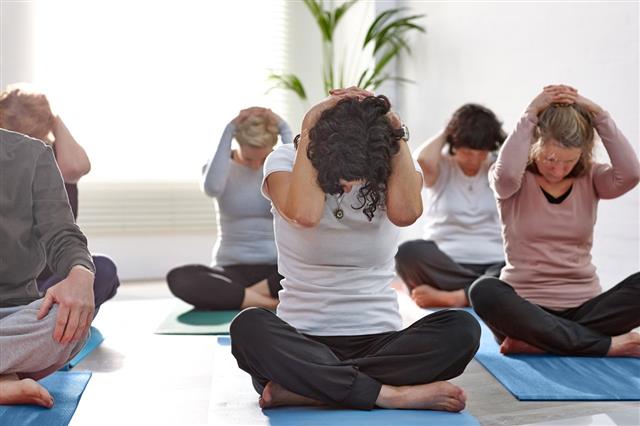 People Exercising During Yoga Class
