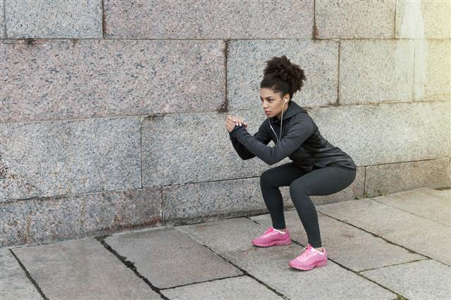 Sporty Woman Doing Warm Up Squat