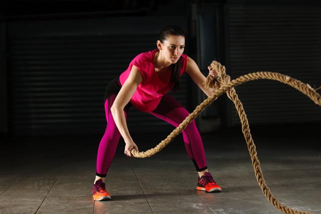 Woman Exercising Using Rope