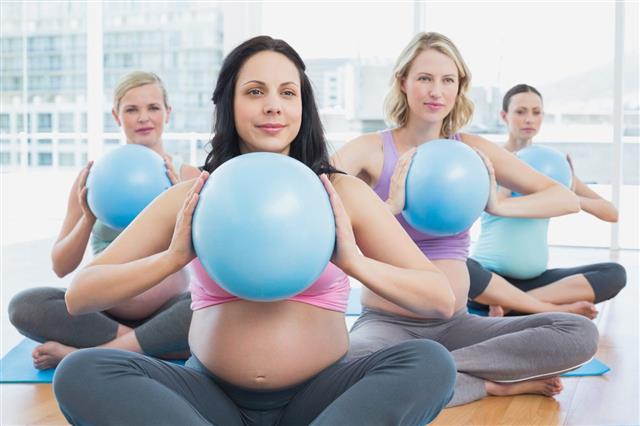 Happy Pregnant Women In Yoga Class