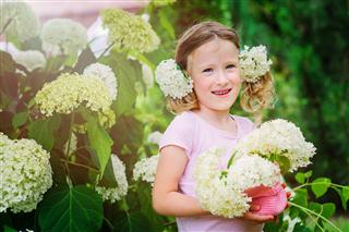 Girl Playing With Hydrangea Flowers