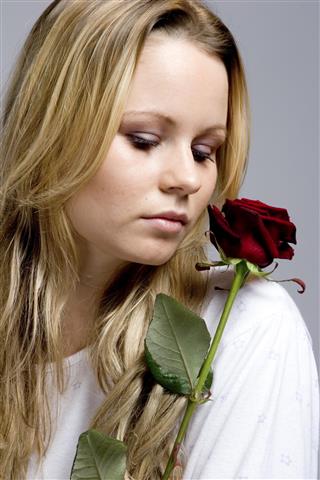 Blond woman with rose