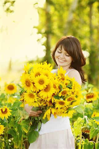 Woman With A Bouquet Of Sunflowers