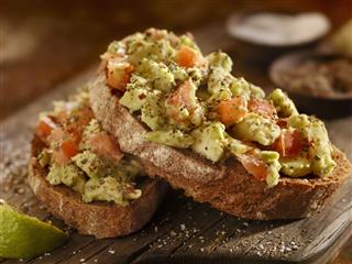 Avocado Toast With Tomatoes On Bread