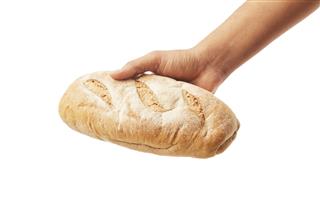 Hand Holds A Long Loaf Of Bread