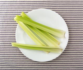 Celery Stalks On A White Plate