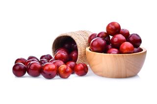 Red Cherry Plum In Wooden Basket