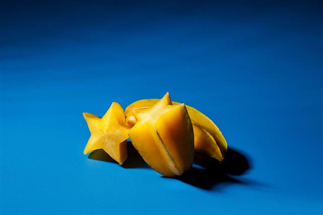Star Fruit And Blue Background