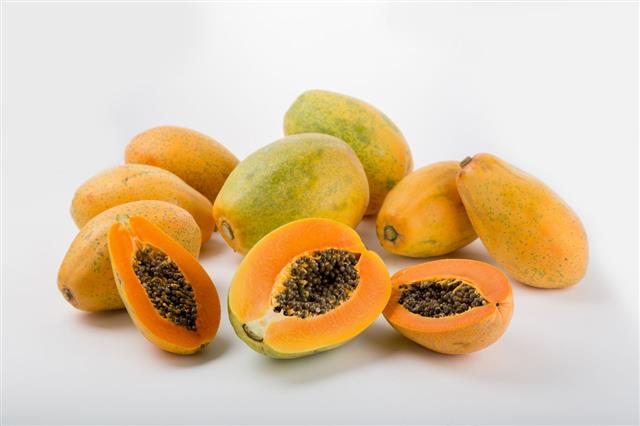 Halved And Whole Papaya Fruits