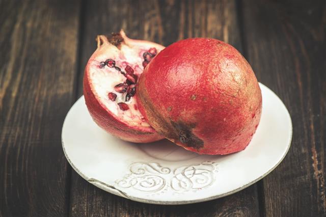 Juicy Pomegranates On Wood