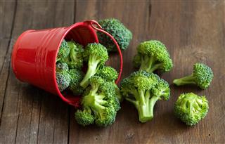 Green broccoli in red bucket