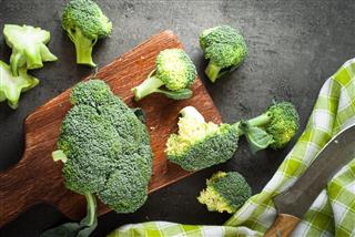 Fresh broccoli at dark table