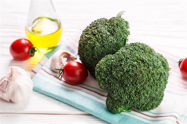 Bunch of fresh green broccoli on wooden background