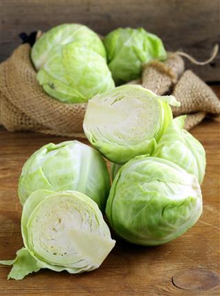 Ripe white cabbage on a wooden table