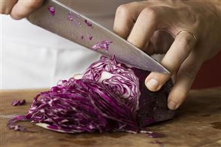 Person chopping red cabbage