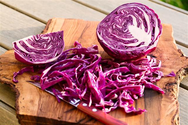 Sliced red cabbage on board