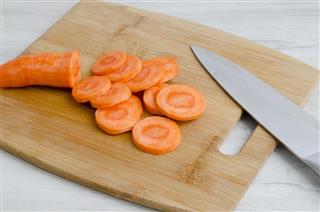 Slices carrots on a chopping Board and a knife