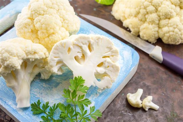 Raw cauliflower on a wooden table