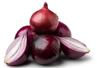 Pyramid of red onions with one cut in half