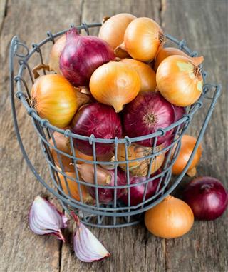 Red and yellow onion in an iron basket