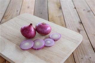 Red onions on wood