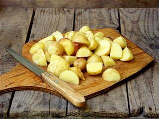Sliced Raw Potatoes And Knife