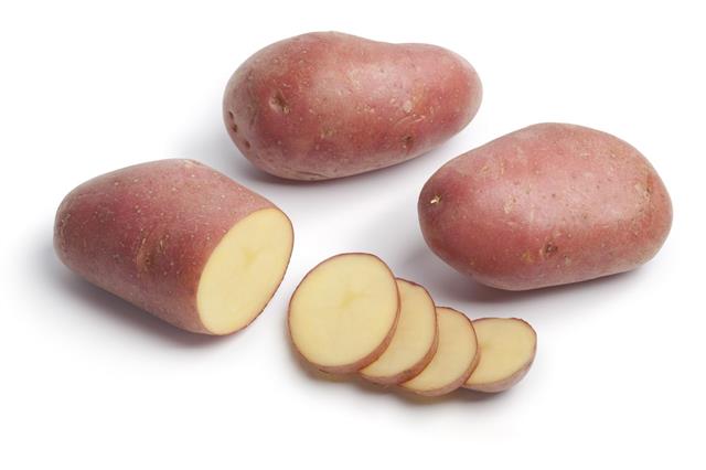 Whole And Sliced Roseval Potatoes