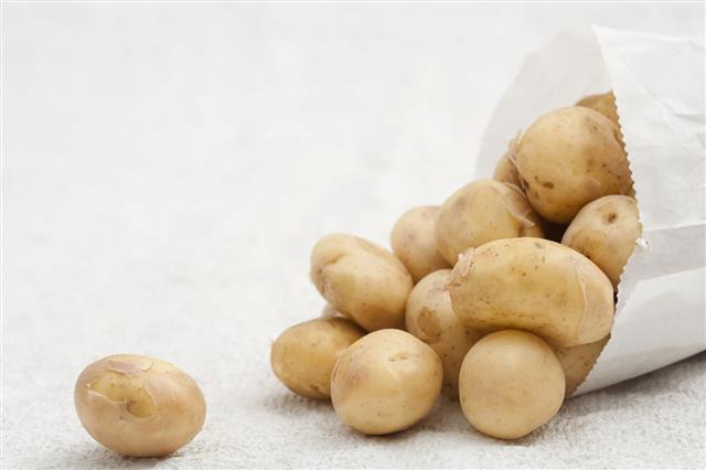 Potatoes Tumbling Out Of A Paper Bag