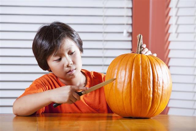 Boy carving a pumpkin