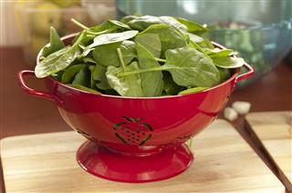 Spinach Leaves In A Red Strainer