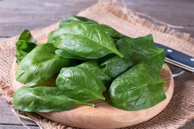 Spinach Leaves On Cutting Board