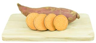 Sweet potato on wooden cutting board