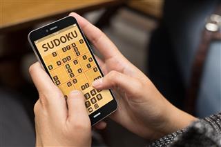 Woman Playing Sudoku