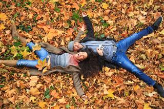 Couple Lying On Leaves