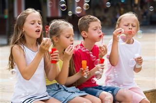 Kids Playing With Soap Bubbles