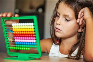 Girl With An Abacus Doing Counting