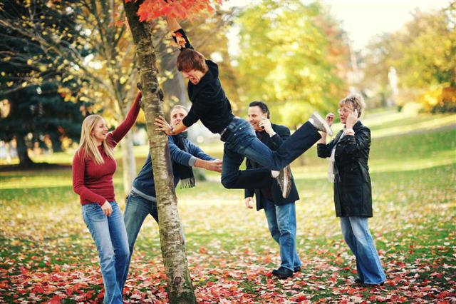 Family Playing In Autumn Park
