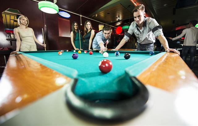 Group Of Young People Playing Billiard