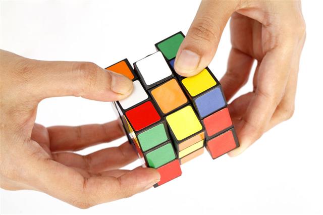 Hands Holding Colorful Rubik Cube