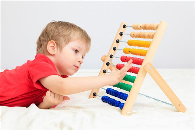 Little Boy Playing With Abacus