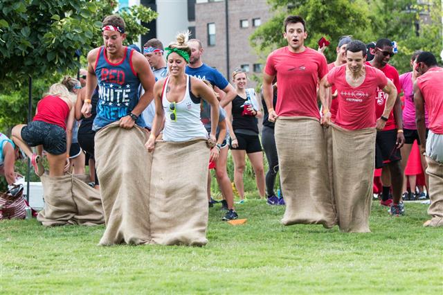 Young Adults Participate In Sack Race